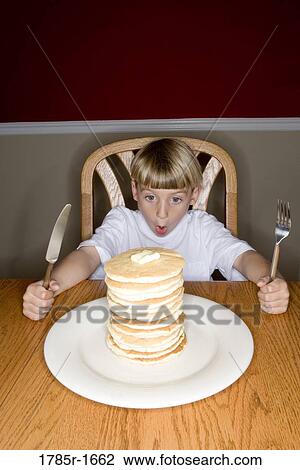 Child ready to eat huge stack of pancakes View Large Photo Image Stock Image - Child ready to eat huge stack of pancakes. Fotosearch