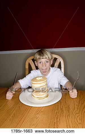 Child ready to eat huge stack of pancakes View Large Photo Image Stock Image - Child ready to eat huge stack of pancakes. Fotosearch