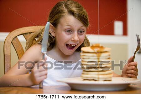 Child ready to eat huge stack of pancakes View Large Photo Image Stock Image - Child ready to eat huge stack of pancakes. Fotosearch
