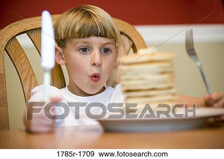 Child ready to eat huge stack of pancakes View Large Photo Image Stock Photo - Child ready to eat huge stack of pancakes. Fotosearch