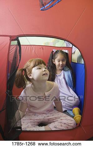 Stock Photo - Children sitting in tent. Fotosearch