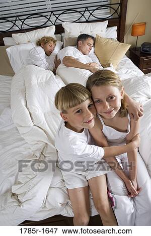 Stock Photo - Children waiting for parents to wake up. Fotosearch