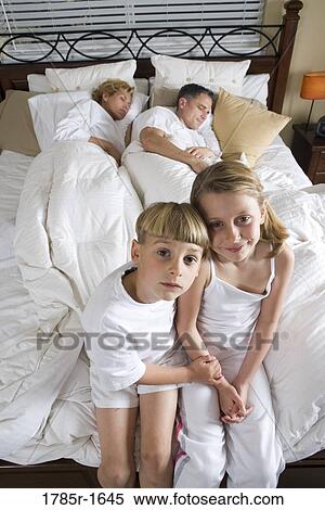 Stock Photography - Children waiting for parents to wake up. Fotosearch