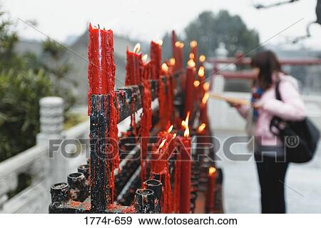 China, Shaanxi, Xian, Woman lighting candle at Big Wild Goose Pagoda View Large Photo Image Stock Photo - China, Shaanxi, Xian, Woman lighting candle at Big Wild Goose Pagoda. Fotosearch