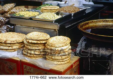 China, Xian, Stack of flat bread and toppings at outdoor food market at Muslim Street View Large Photo Image Stock Image - China, Xian, Stack of flat bread and toppings at outdoor food market at Muslim Street. Fotosearch