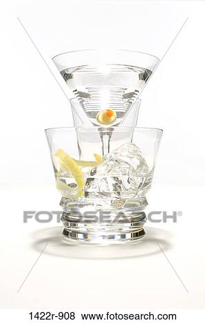 Clear cocktail glasses with ice, olive and lemon View Large Photo Image Stock Photo - Clear cocktail glasses with ice, olive and lemon. Fotosearch