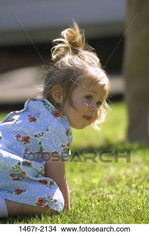 Picture - Close-up of a baby girl in a park. Fotosearch
