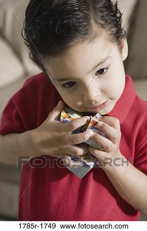 Stock Photo - Close-up of a boy holding toys. Fotosearch