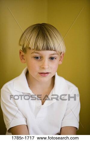 Close-up of a boy looking down View Large Photo Image Stock Photo - Close-up of a boy looking down. Fotosearch