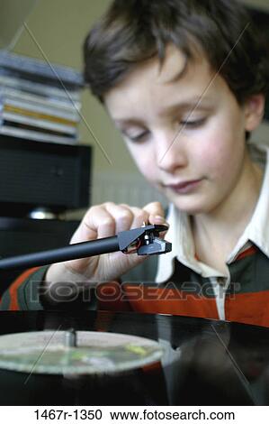 Close-up of a boy operating a turntable View Large Photo Image Stock Image - Close-up of a boy operating a turntable. Fotosearch