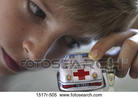 Close-up of a boy playing with a toy car View Large Photo Image Stock Photography - Close-up of a boy playing with a toy car. Fotosearch