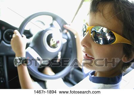 Close-up of a boy sitting in a car View Large Photo Image Picture - Close-up of a boy sitting in a car. Fotosearch