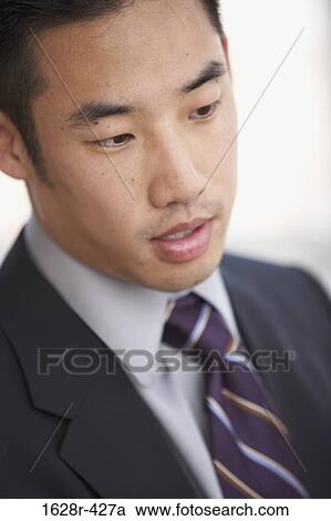 Close-up of a businessman looking serious View Large Photo Image Stock Image - Close-up of a businessman looking serious. Fotosearch