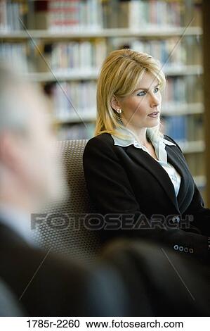 Stock Image - Close-up of a businesswoman in meeting. Fotosearch