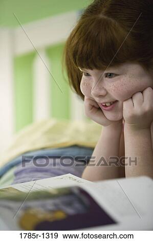 Close-up of a child reading a book View Large Photo Image Stock Photo - Close-up of a child reading a book. Fotosearch