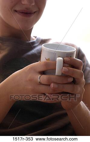 Close-up of a coffee mug in a woman's hands View Large Photo Image Stock Image - Close-up of a coffee mug in a woman's hands. Fotosearch