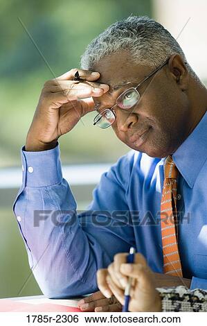 Close-up of a contemplative businessman View Large Photo Image Stock Photograph - Close-up of a contemplative businessman. Fotosearch