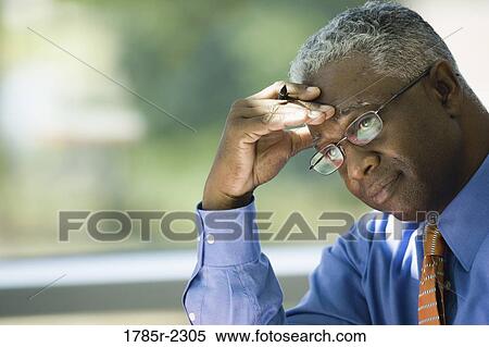 Close-up of a contemplative businessman View Large Photo Image Stock Photography - Close-up of a contemplative businessman. Fotosearch