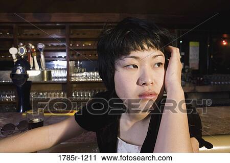 Close-up of a contemplative young Asian woman View Large Photo Image Stock Image - Close-up of a contemplative young Asian woman. Fotosearch