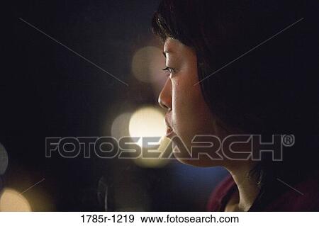 Close-up of a contemplative young Asian woman View Large Photo Image Stock Photo - Close-up of a contemplative young Asian woman. Fotosearch