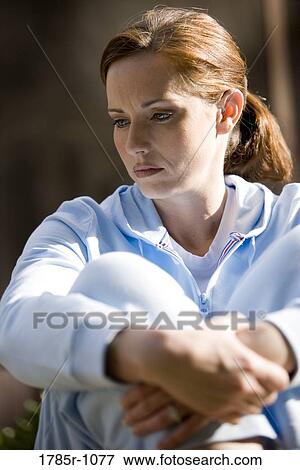 Close-up of a contemplative young woman View Large Photo Image Stock Photo - Close-up of a contemplative young woman. Fotosearch