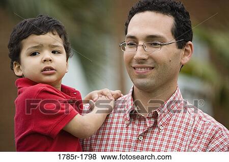 Stock Photo - Close-up of a father carrying son. Fotosearch