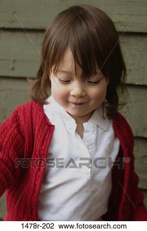 Close-up of a girl grinning View Large Photo Image Stock Image - Close-up of a girl grinning. Fotosearch