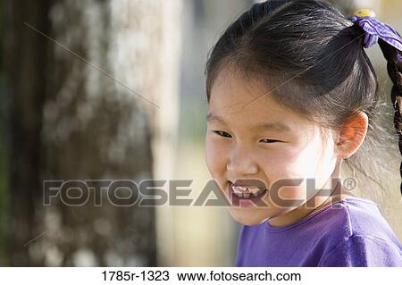 Close-up of a girl smiling View Large Photo Image Stock Image - Close-up of a girl smiling. Fotosearch