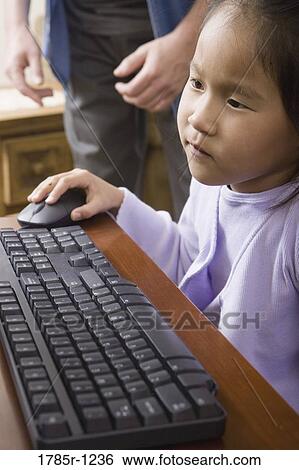 Stock Photograph - Close up of a girl using computer. Fotosearch
