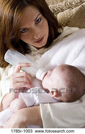 Close-up of a mother bottle-feeding baby View Large Photo Image Stock Image - Close-up of a mother bottle-feeding baby. Fotosearch
