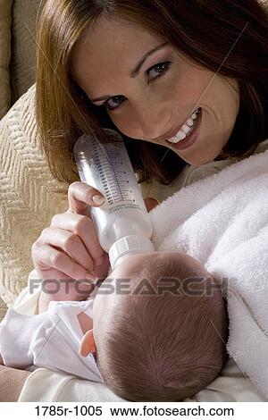 Close-up of a mother bottle-feeding baby View Large Photo Image Stock Photography - Close-up of a mother bottle-feeding baby. Fotosearch