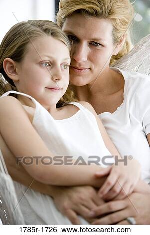 Close-up of a mother with her daughter sitting in a hammock View Large Photo Image Stock Photograph - Close-up of a mother with her daughter sitting in a hammock. Fotosearch