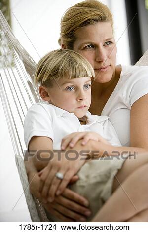 Picture - Close-up of a mother with her son sitting in a hammock. Fotosearch