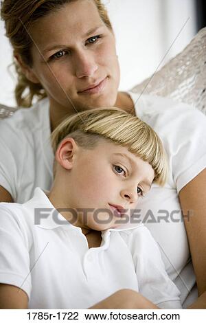 Stock Image - Close-up of a mother with her son sitting in a hammock. Fotosearch