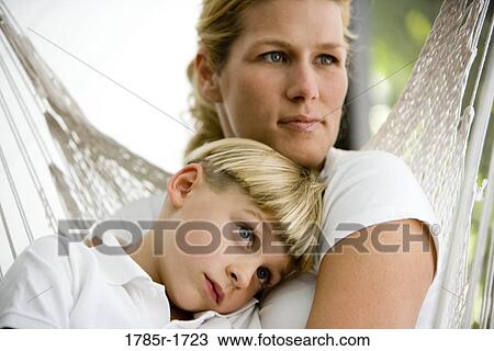 Stock Image - Close-up of a mother with her son sitting in a hammock. Fotosearch