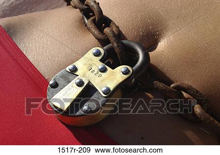 Close-up of a padlock and chain on a person's stomach View Large Photo Image Stock Photo - Close-up of a padlock and chain on a person's stomach. Fotosearch