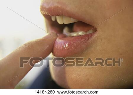 Close-up of a person's finger on their lips View Large Photo Image Stock Image - Close-up of a person's finger on their lips. Fotosearch