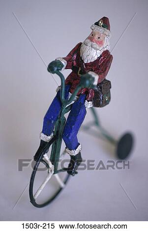 Close-up of a Santa Claus doll riding a bicycle View Large Photo Image Stock Photography - Close-up of a Santa Claus doll riding a bicycle. Fotosearch