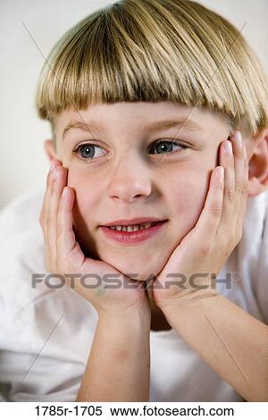 Close-up of a smiling boy with hands on cheeks View Large Photo Image Stock Photography - Close-up of a smiling boy with hands on cheeks. Fotosearch