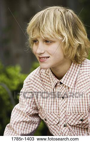 Stock Image - Close-up of a teenage boy smiling. Fotosearch