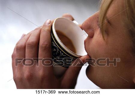 Close-up of a woman drinking from a cup View Large Photo Image Stock Photo - Close-up of a woman drinking from a cup. Fotosearch