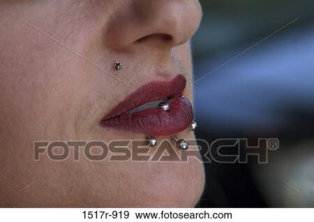 Close-up of a woman with pierced lips View Large Photo Image Stock Photo - Close-up of a woman with pierced lips. Fotosearch