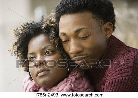 Stock Image - Close-up of a young couple embracing. Fotosearch