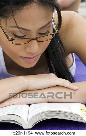 Close-up of a young woman reading a book View Large Photo Image Picture - Close-up of a young woman reading a book. Fotosearch