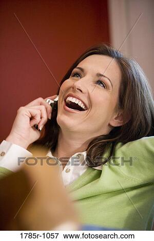 Close-up of a young woman talking on mobile phone View Large Photo Image Stock Photo - Close-up of a young woman talking on mobile phone. Fotosearch