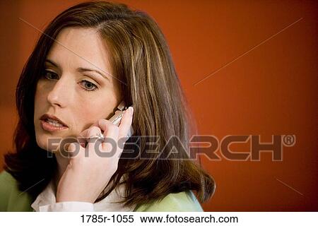 Close-up of a young woman talking on mobile phone View Large Photo Image Stock Photography - Close-up of a young woman talking on mobile phone. Fotosearch