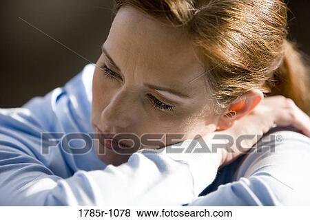 Stock Photo - Close-up of a young woman thinking. Fotosearch