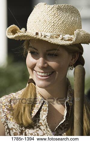 Close-up of a young woman wearing cowboy hat View Large Photo Image Picture - Close-up of a young woman wearing cowboy hat. Fotosearch