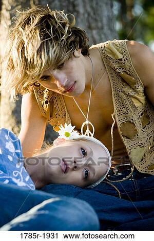 Stock Image - Close-up of affectionate young hippie couple. Fotosearch