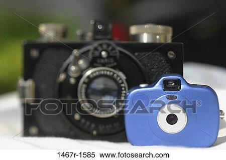 Close-up of an analogue camera and a digital camera View Large Photo Image Stock Photography - Close-up of an analogue camera and a digital camera. Fotosearch